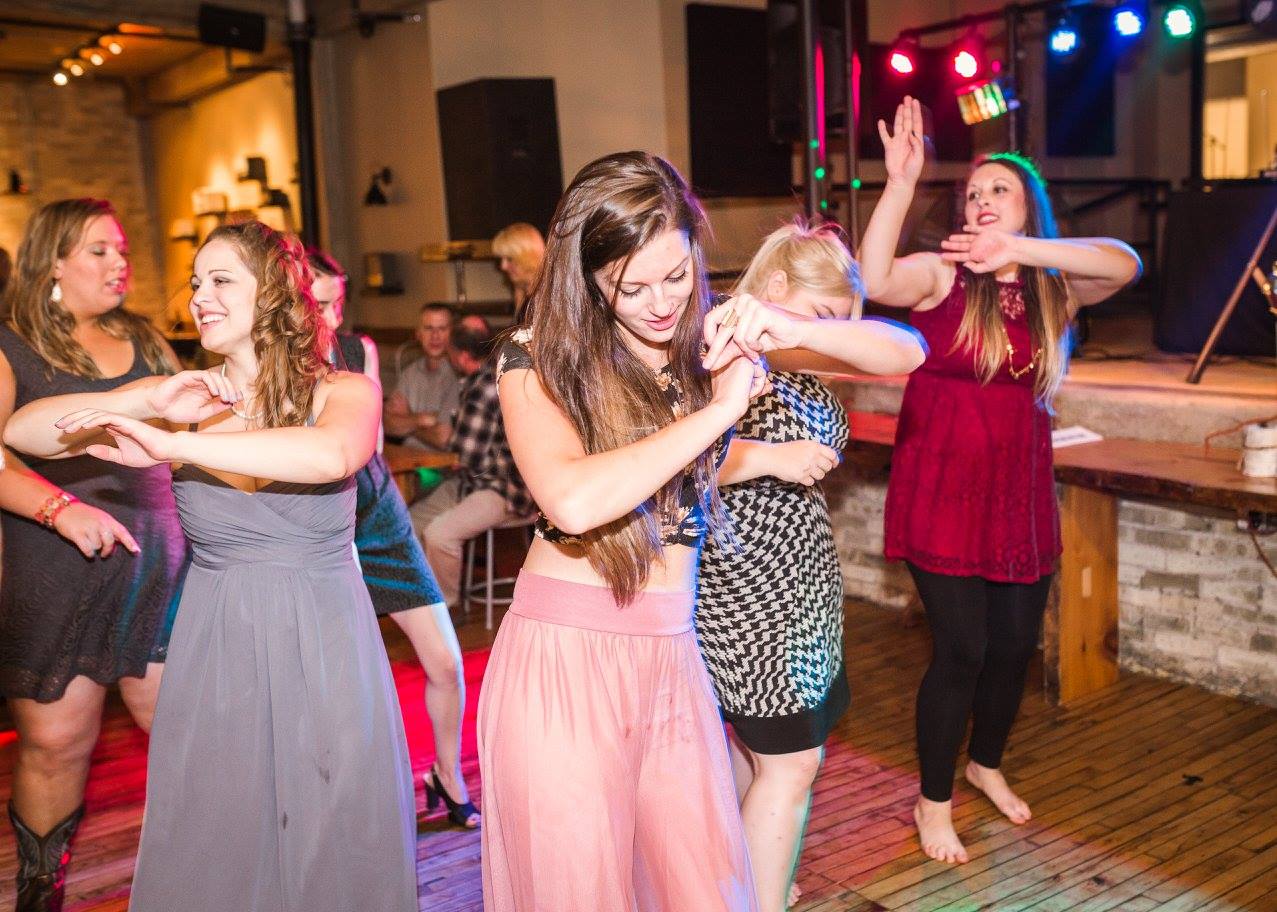 guests dancing on the dance floor at a wedding, doing the wobble