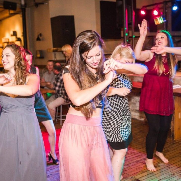 guests dancing on the dance floor at a wedding, doing the wobble
