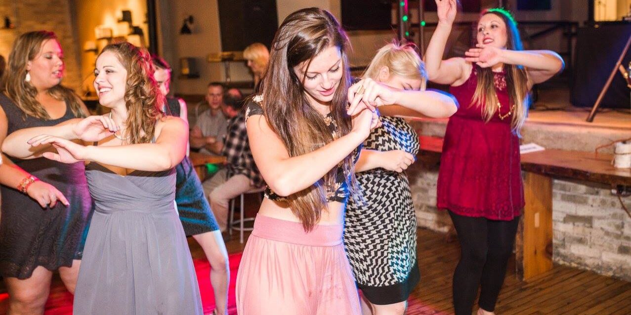 guests dancing on the dance floor at a wedding, doing the wobble